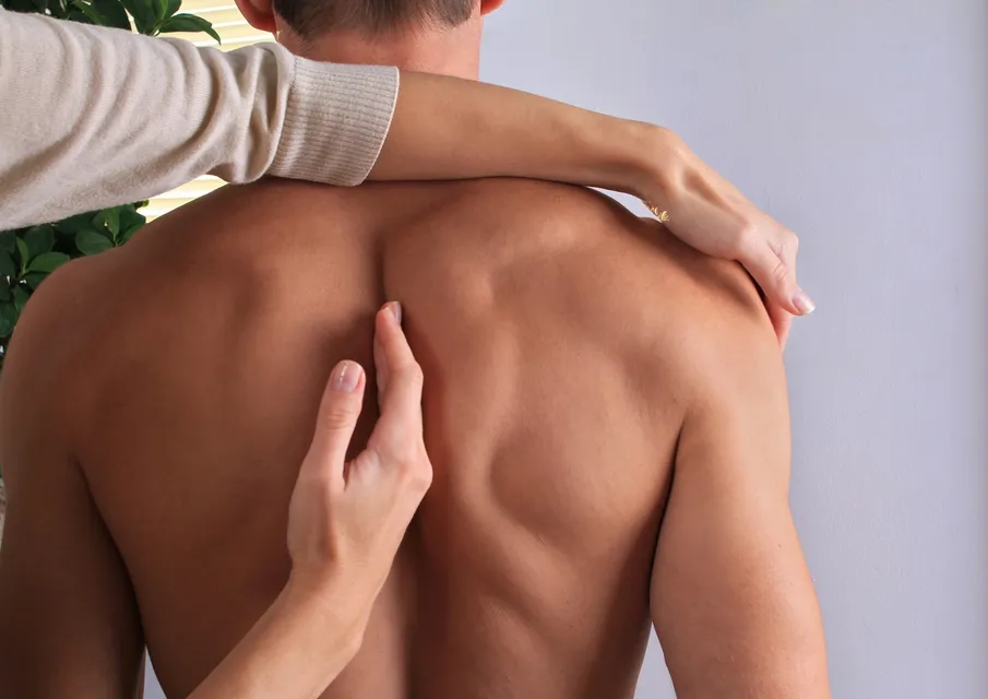 Hands-on spinal alignment and fascial bodywork assessment at Trust Your Fascia in Boulder